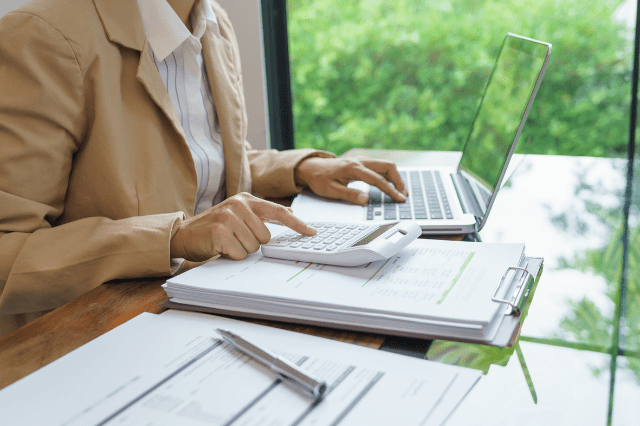 Teacher calculating finances to avoid mortgage mistakes in Australia