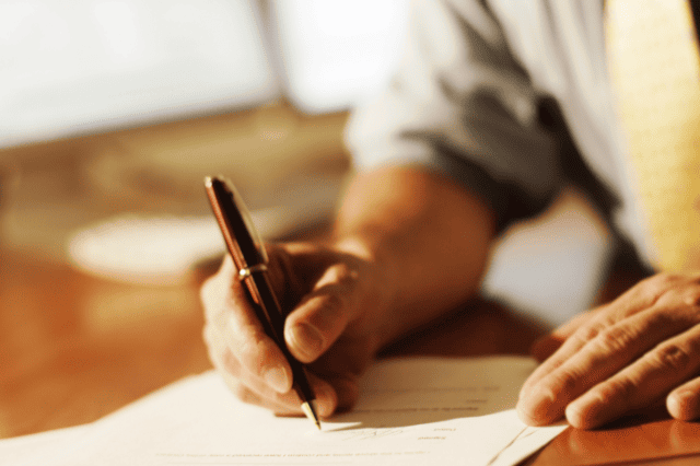 Trustee reviewing paperwork — comparing SMSF loan options from non-bank lenders. Trustee reviewing paperwork — comparing SMSF loan options from non-bank lenders.