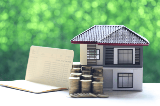 Model house and coins — visualising SMSF gearing risks and liquidity planning needs.