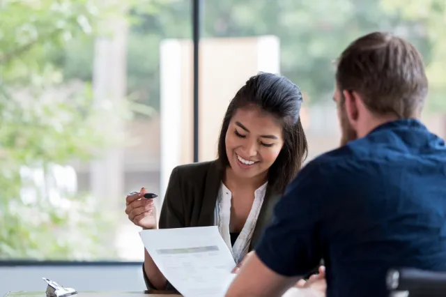 Trustee discussing ATO SMSF rulings — reviewing loan variation documents with adviser. Trustee discussing ATO SMSF rulings — reviewing loan variation documents with adviser.