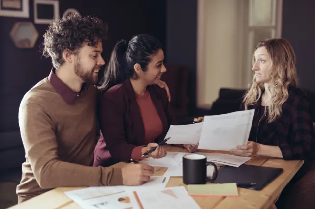 Couple meeting with adviser — planning strategy for SMSF loan refinancing process. Couple meeting with adviser — planning strategy for SMSF loan refinancing process.